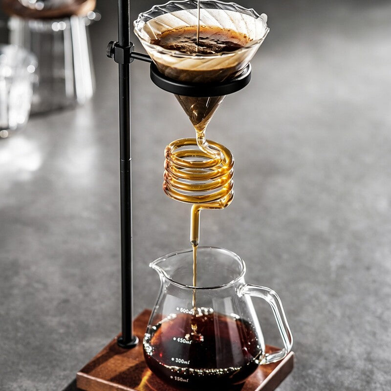 Spiral pour-over coffee stand dripping into glass carafe