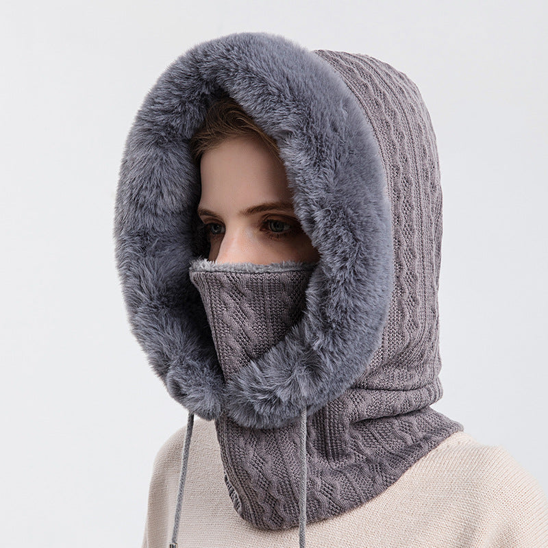 Model wearing gray plush winter hood and neck cover
