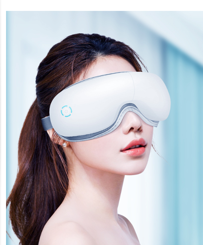 Model wearing a light blue electronic eye massager