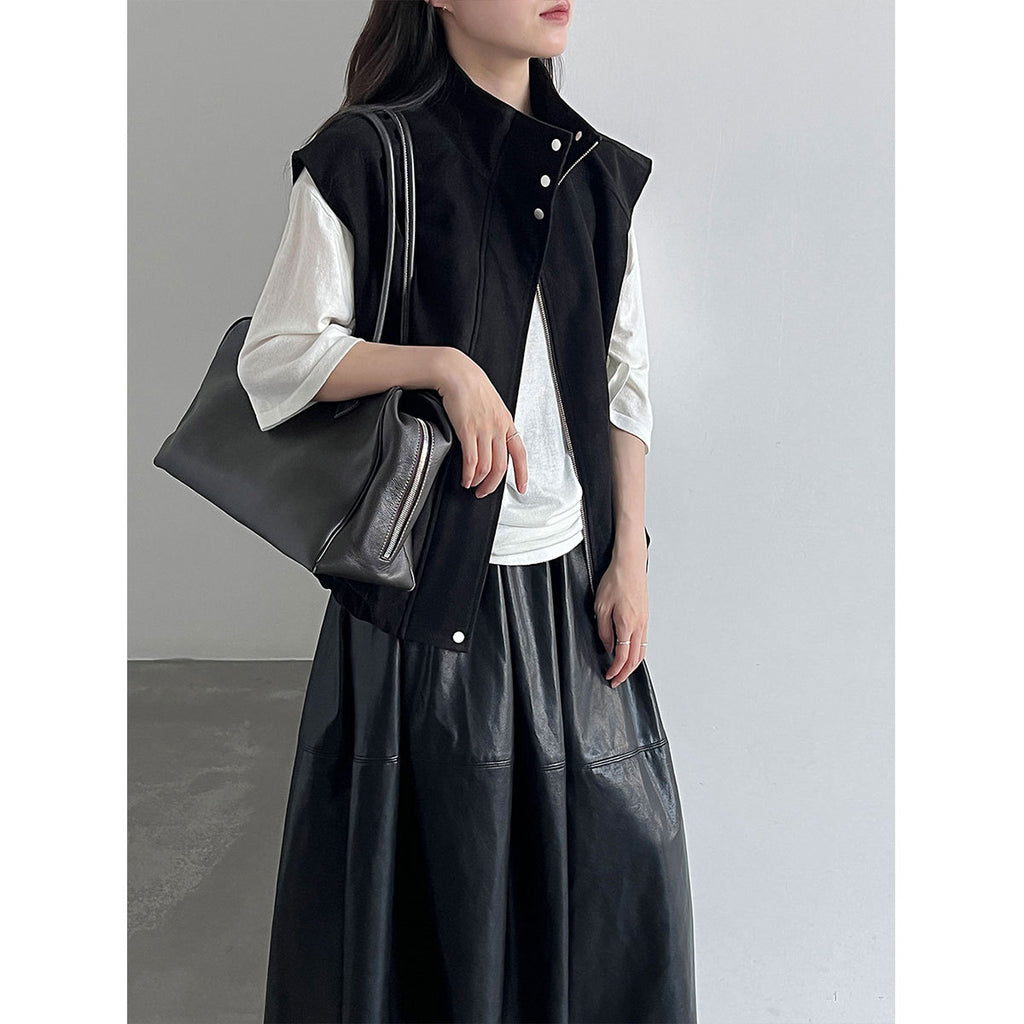 Model wearing a black sleeveless stand-collar vest