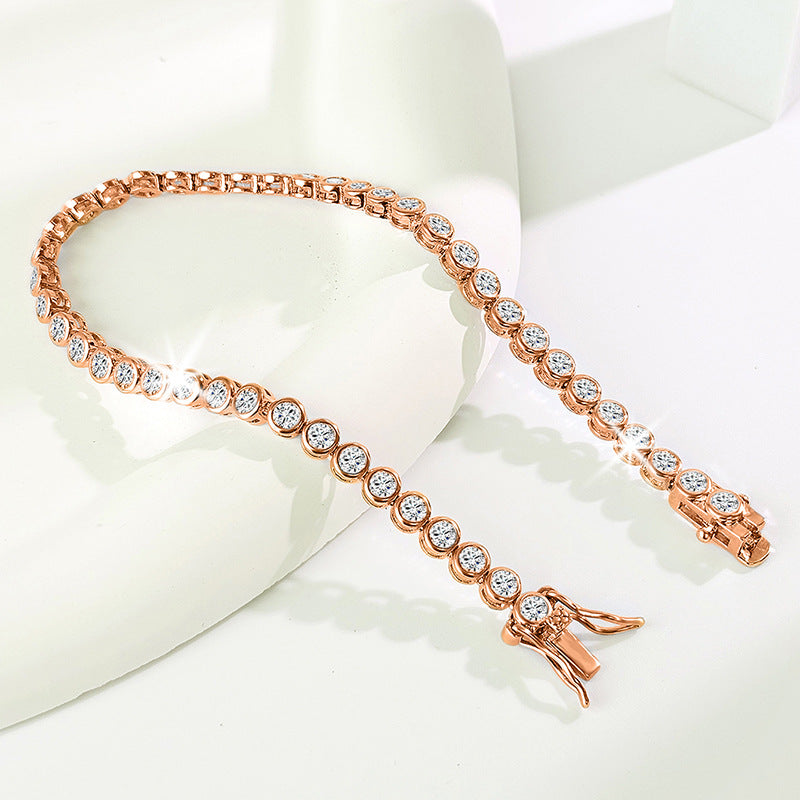Gold-tone round-stone bracelet on a white stand