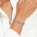 Silver-tone Cuban chain bracelet shown on a wrist