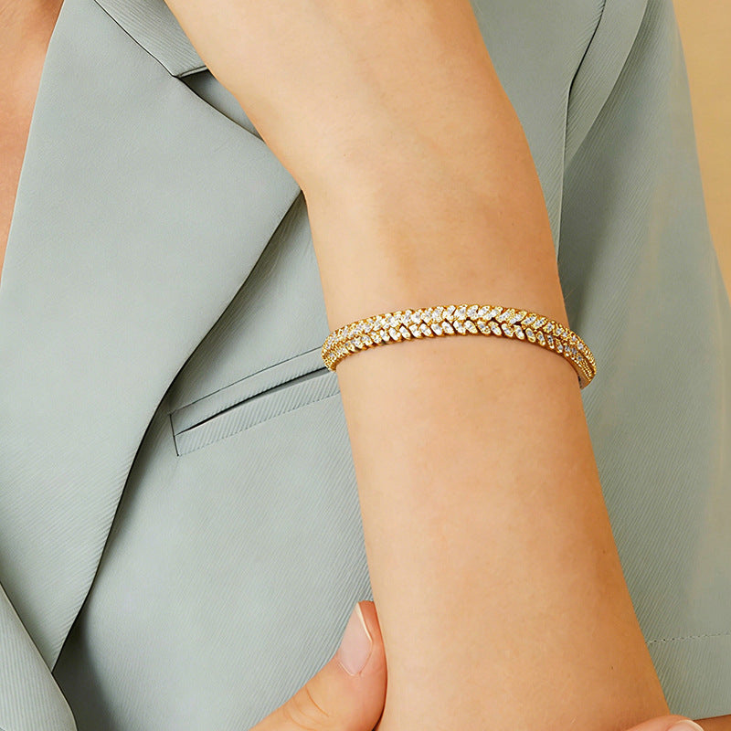 Gold-tone stone bracelet shown on a wrist