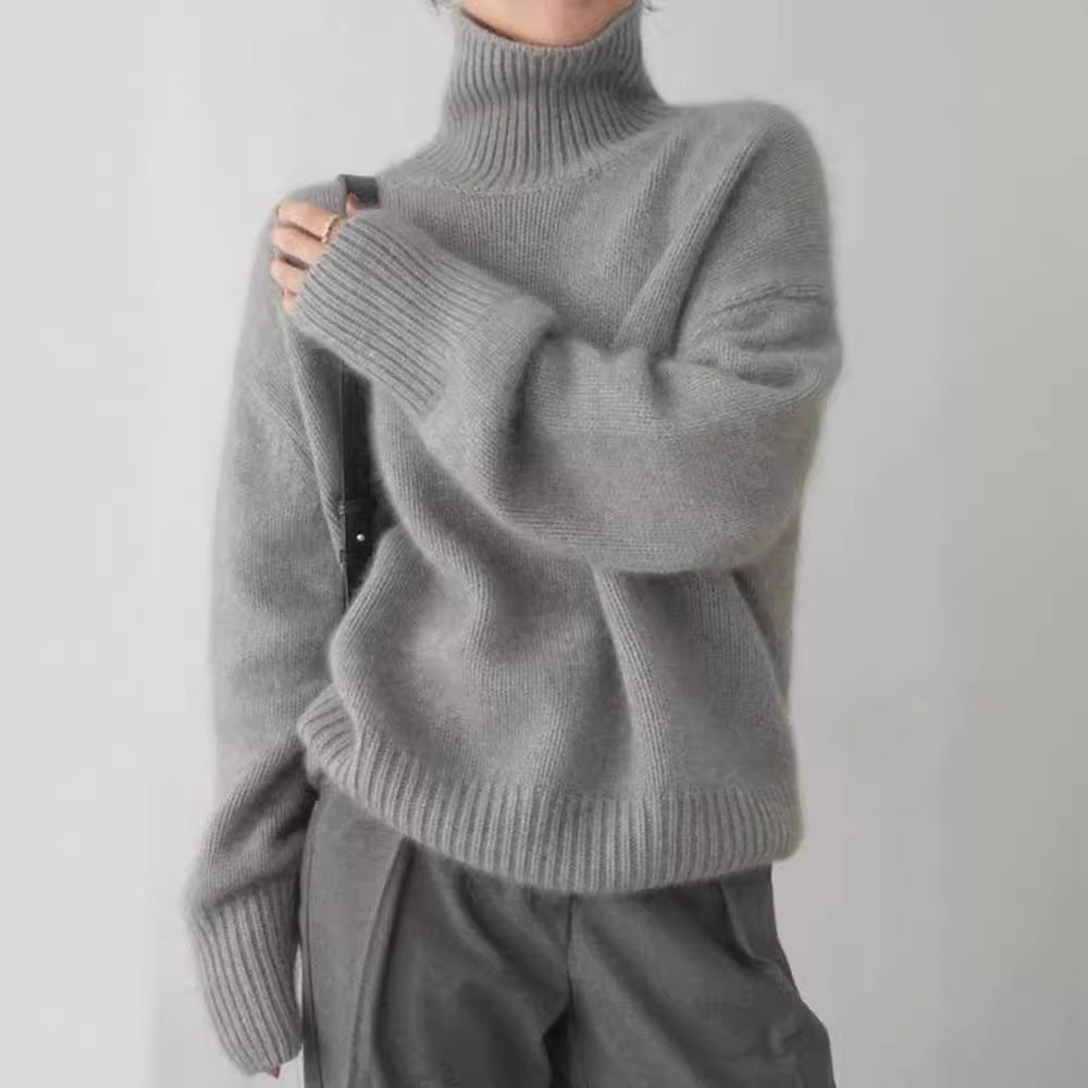 Model wearing a gray high-neck knit sweater